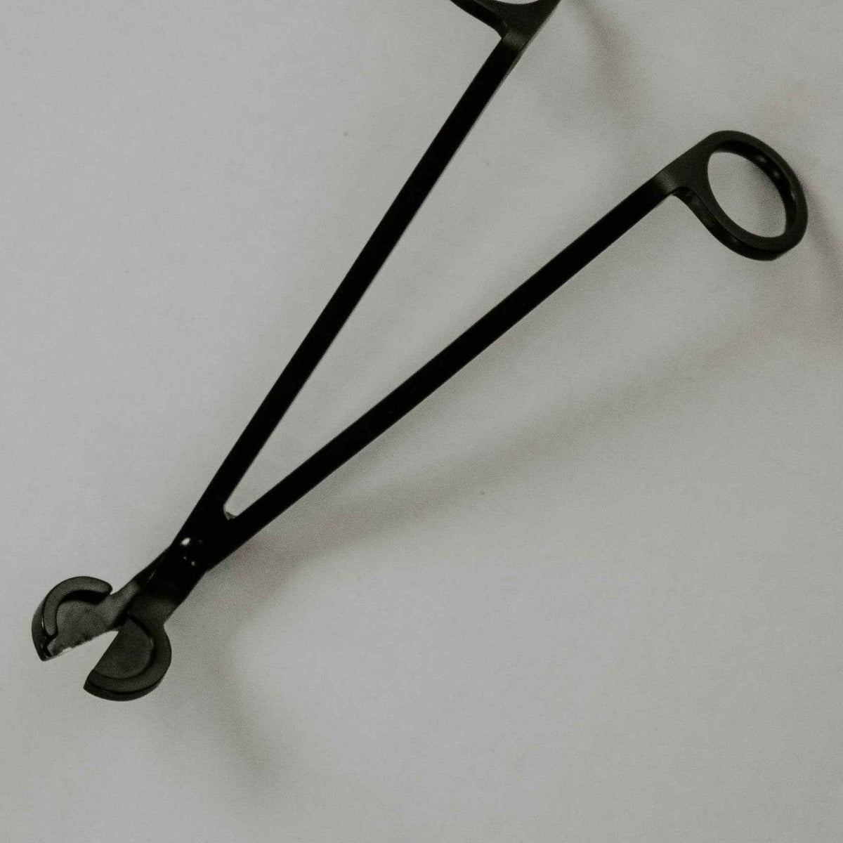 Black Candle Care Kit with matte black metal wick trimmer, featuring long loop handles and curved cutting blades.