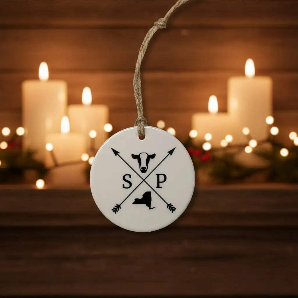 Ceramic Local printed Ornaments featuring a white round disc with black crossed arrows, S P letters, and state silhouette.