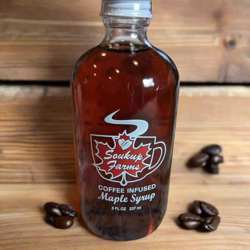 Maple syrup bottle, NY MAPLE PRODUCTS BY SOUKUP FARMS, amber coffee-infused syrup in clear glass with white label.