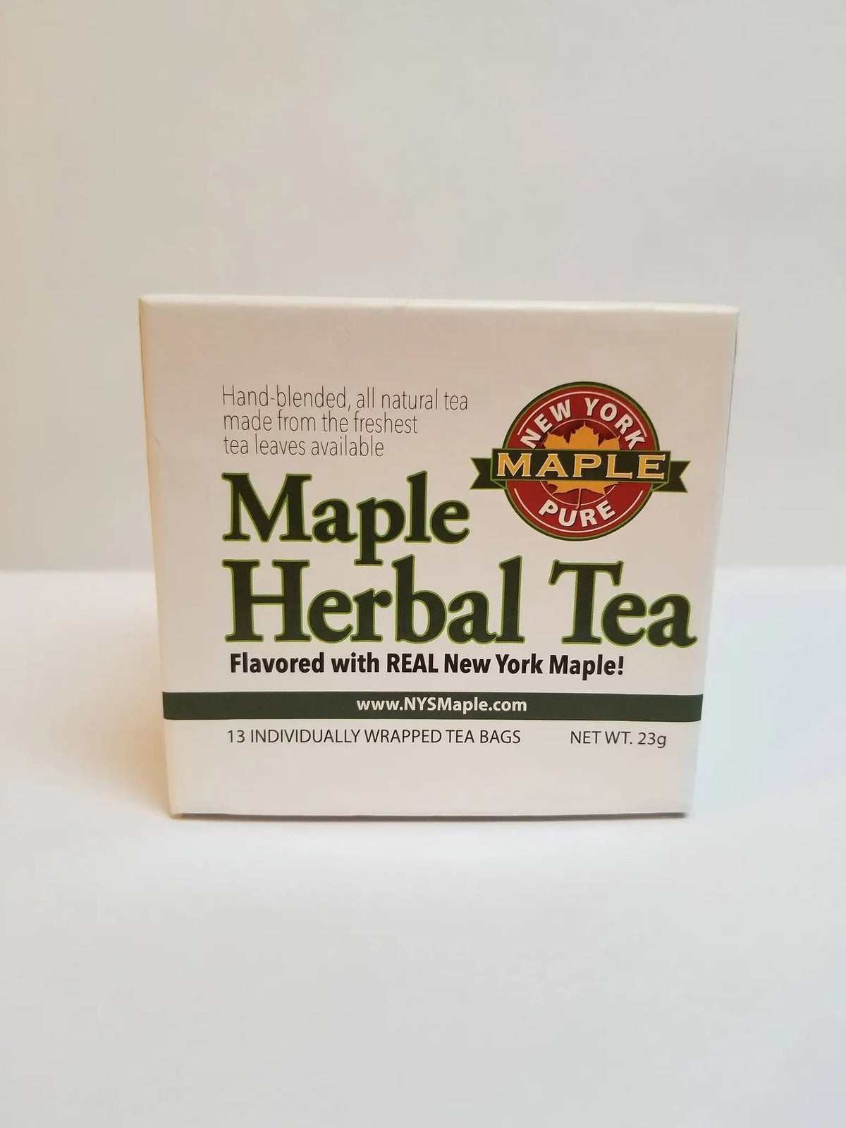 Maple Herbal Tea in a cream-colored paper box with bold green lettering and a red New York maple badge