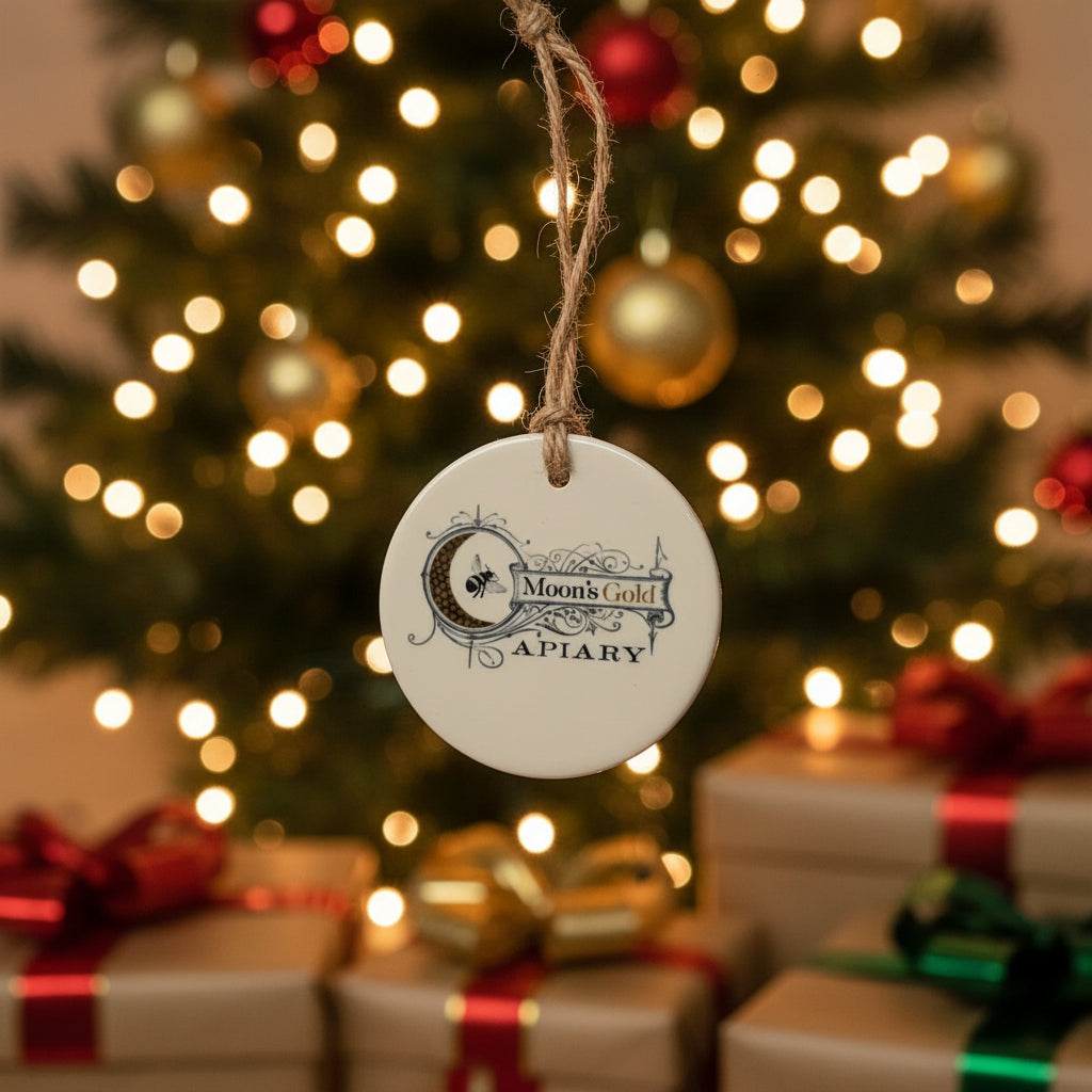 Round ceramic tag with 'Moon's Gold Apiary' text and logo on a beige background