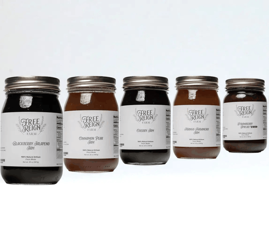 Amish Made Jam in glass jars, featuring assorted dark purple, red, and amber fruit spreads with white labels and metal lids.