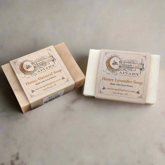 MOON'S GOLD COLD-PROCESSED SOAPS in tan honey oatmeal and white honey lavender bars, wrapped with printed labels.