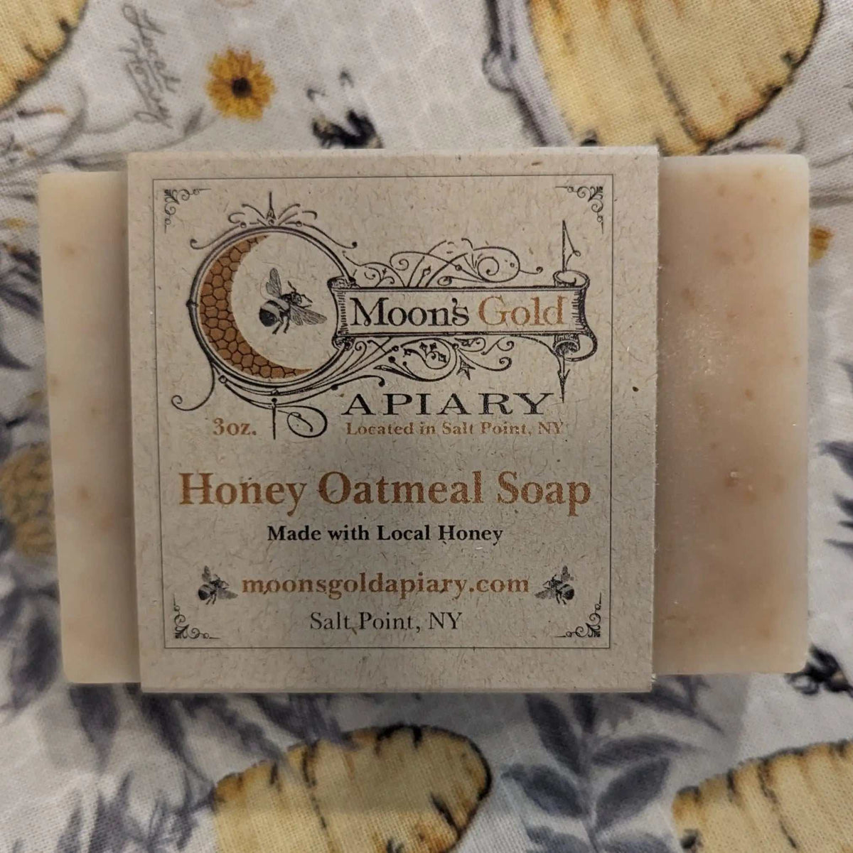 MOON'S GOLD SOAP BUNDLE featuring a beige honey oatmeal soap bar in rustic kraft paper packaging with ornate bee branding