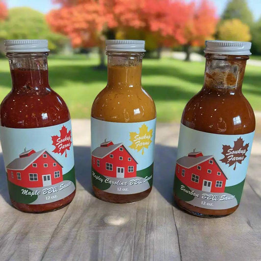 BBQ sauce bottles in red, golden brown and brown, with white farm labels; NY MAPLE PRODUCTS BY SOUKUP FARMS appears on each label.