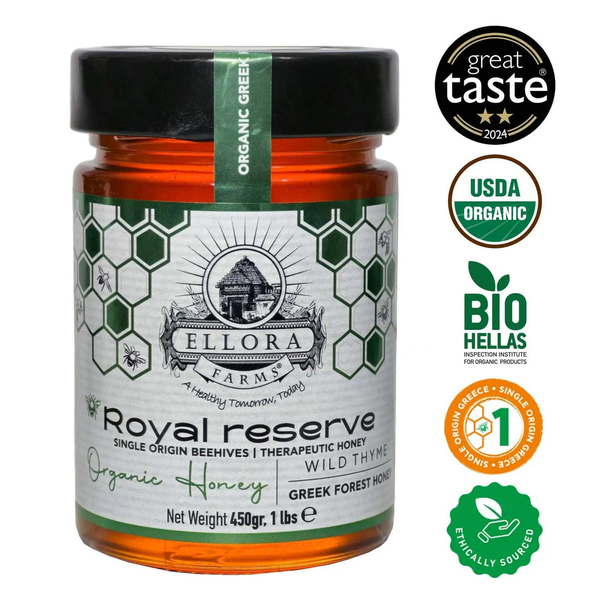 Organic Greek Raw Honey in an amber glass jar with a black lid, green-and-white label, and Wild Thyme variety.