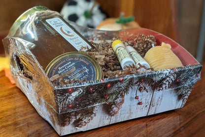 Gift basket MOON'S GOLD SM GIFT BASKET with honey, beeswax cream, lip balms and candle in a rustic printed box, wrapped in clear plastic.