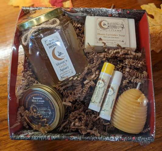 MOON'S GOLD SM GIFT BASKET with a jar of honey, beeswax skin cream, two lip balms, soap, and a golden skep candle.